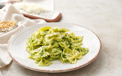 Pasta with pesto on a white plate