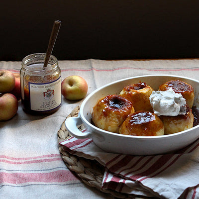 Sicilian Baked Apples in a white bowl with an open jar of marmalade