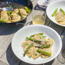 The Pasta Shop Tender Green & Spring Herb Ravioli with asparagus in a white bowl