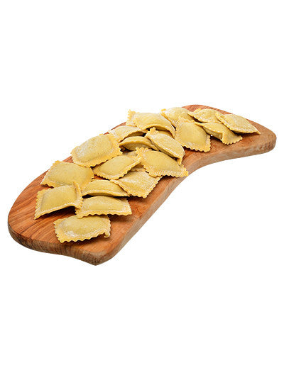 Fresh ravioli on a wood board