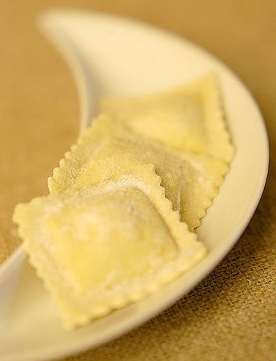 Close up of fresh ravioli stuffed with ricotta and lemon