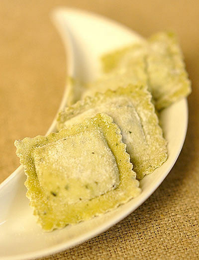 Fresh ravioli on a white plate