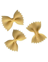 Three dried Farfalloni pasta against a white background
