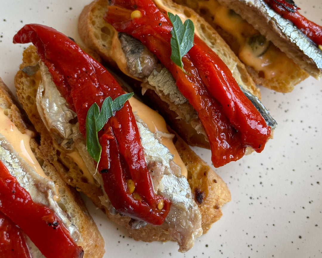 Crostini topped with piquillo peppers, sardines and spicy mayonnaise