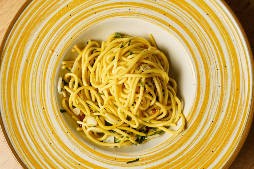 Spaghetti Aglio e Olio on a yellow plate