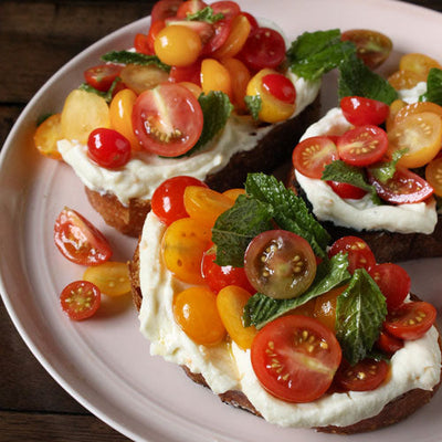 Lemony Whipped Ricotta Toasts with Cherry Tomatoes & Mint