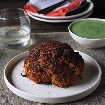 Spiced Whole Roasted Cauliflower with Green Herb Yogurt Sauce