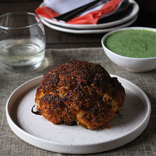 Spiced Whole Roasted Cauliflower with Green Herb Yogurt Sauce