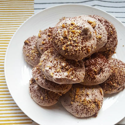 Chocolate and hazelnut meringues on a white plate