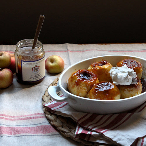 Sicilian Baked Apples in a white bowl with an open jar of marmalade