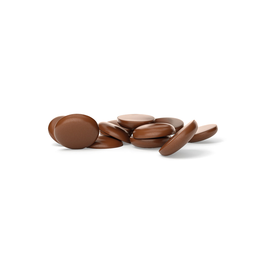 Milk chocolate drops on a white background