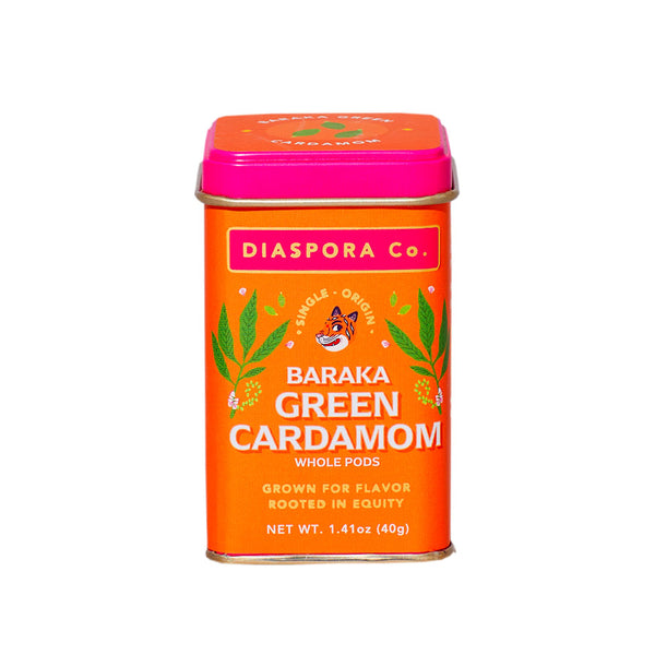 Orange and pink tin of Diaspora Baraka Green Cardmamom pods