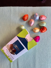 Individually wrapped Giraudi chocolate Easter eggs spilling out of their box