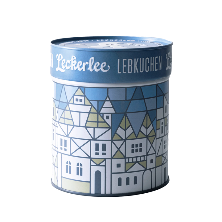 Decorative cylindrical tin with geometric house pattern and 'Leckerlee' branding on a white background