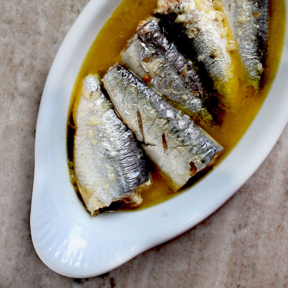 Marinated sardines in a white dish