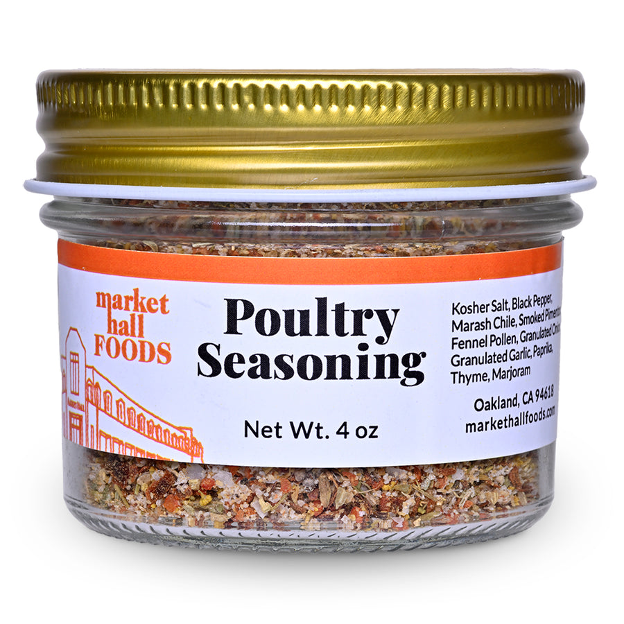 A 4 oz glass jar of Market Hall Foods Poultry Seasoning, featuring a textured gold metal lid and a white label with orange and black text, set against a plain white background.