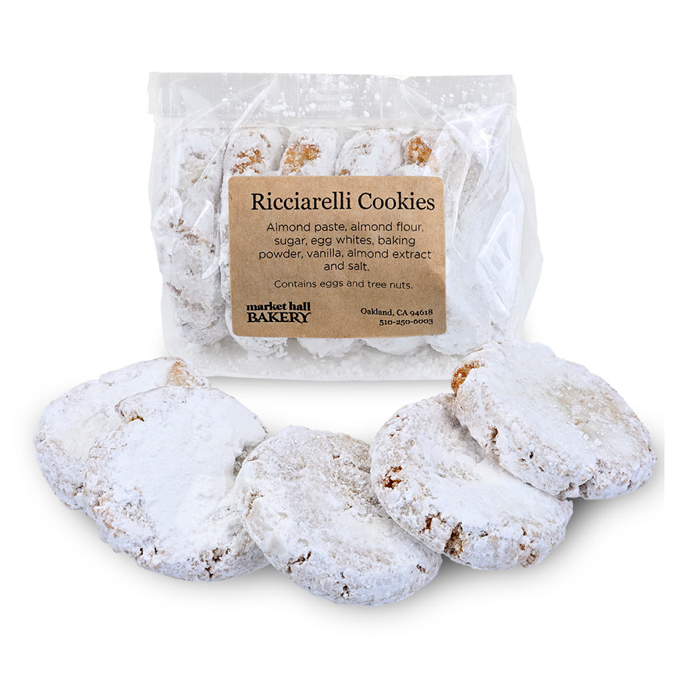 A clear stand-up pouch labeled 'Ricciarelli Cookies' with several powdered white cookies displayed in front on a white background.