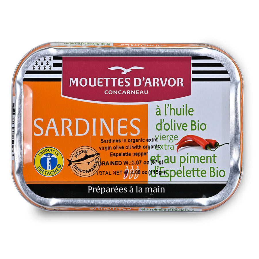 A rectangular tin of Mouettes d'Arvor Concarneau Sardines on a plain white background. The packaging features a bright orange and white label with green and red text, and a silver metallic foil border.
