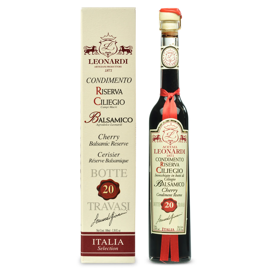 Bottle of balsamic vinegar with a box labeled 'Leonardi' on a white background