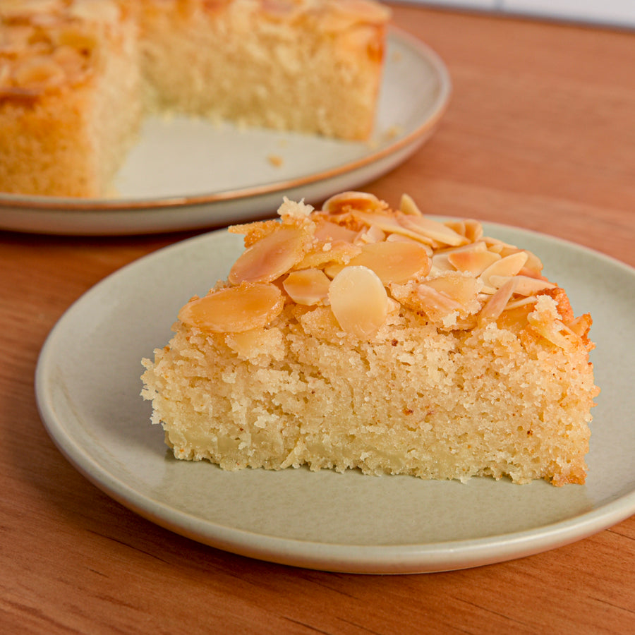 Slice of almond cake on a blue plate