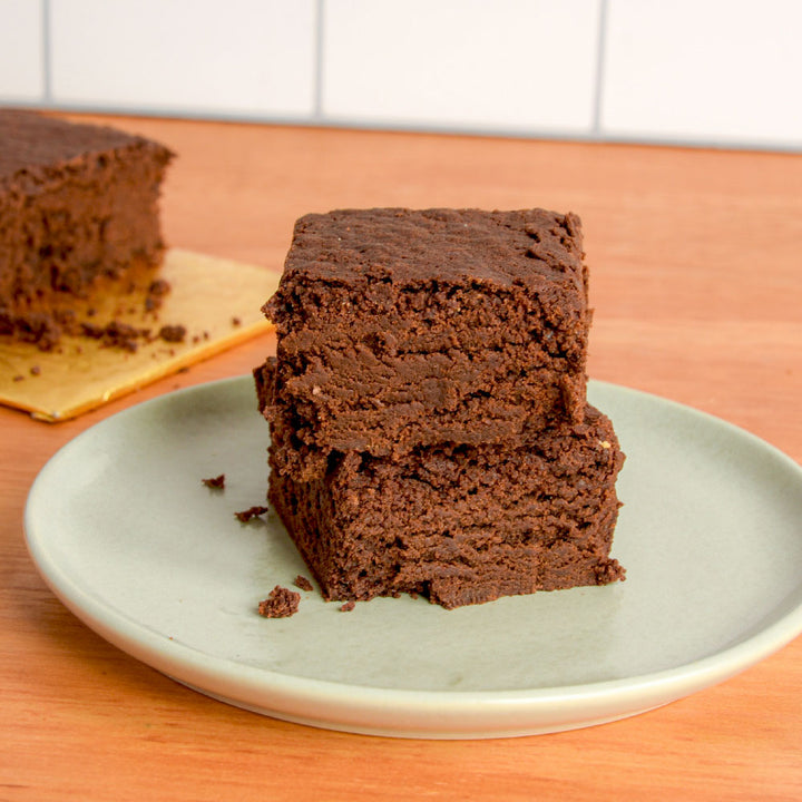 Two chocolate brownies stacked on top of each other