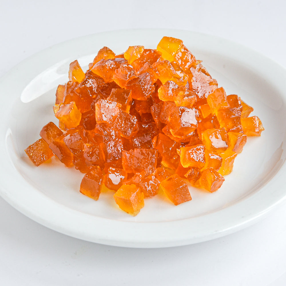 Candied pear cubes on a white plate