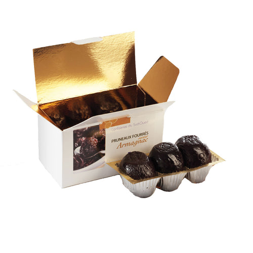Open box of Coufidou Agen Prunes Stuffed with Armagnac Mousse with three prunes outside the box