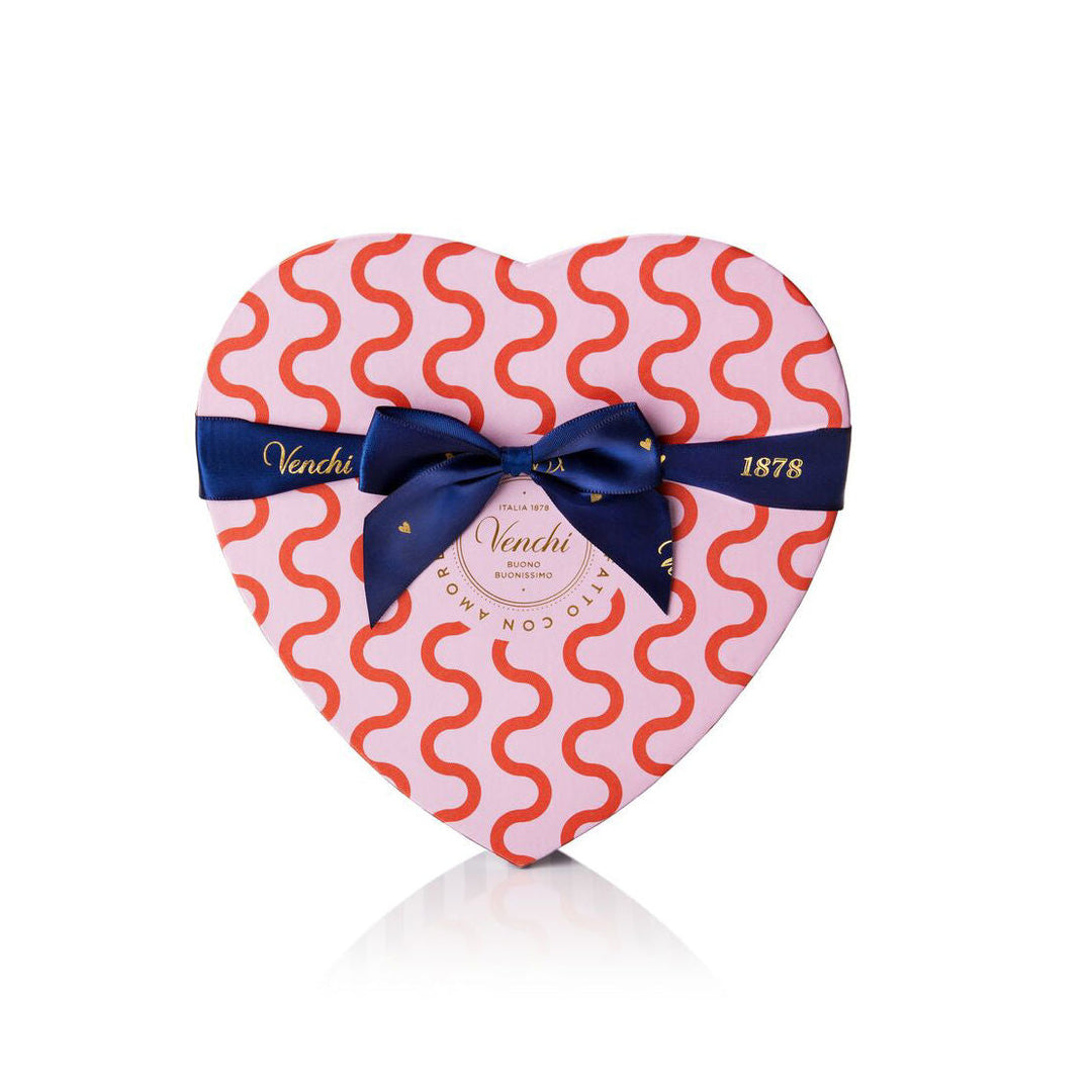 Pink and red heart-shaped box tied with a blue ribbon