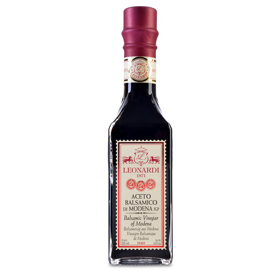 A bottle of Balsamic Vinegar from Modena with a red seal, labeled as 'Aceto Balsamico di Modena IGP' with the Leonardi family emblem.