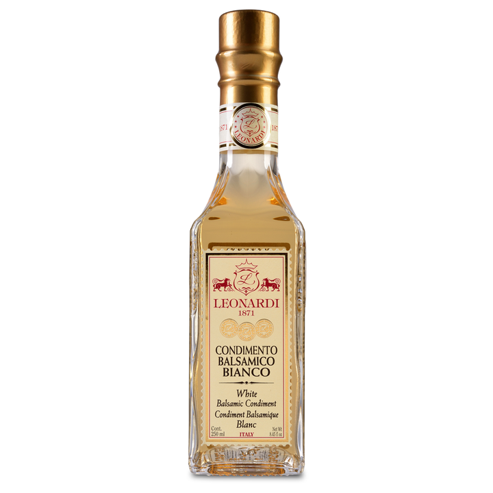 A bottle of Acetaia Leonardi White Balsamic Condiment with a golden-hued liquid visible through the transparent glass.
