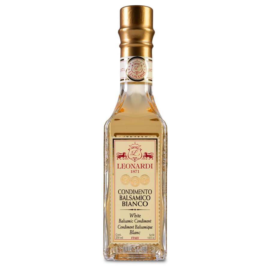 A bottle of Acetaia Leonardi White Balsamic Condiment with a golden-hued liquid visible through the transparent glass.