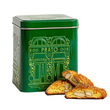 Three pieces of almond biscotti in front of a green gift tin