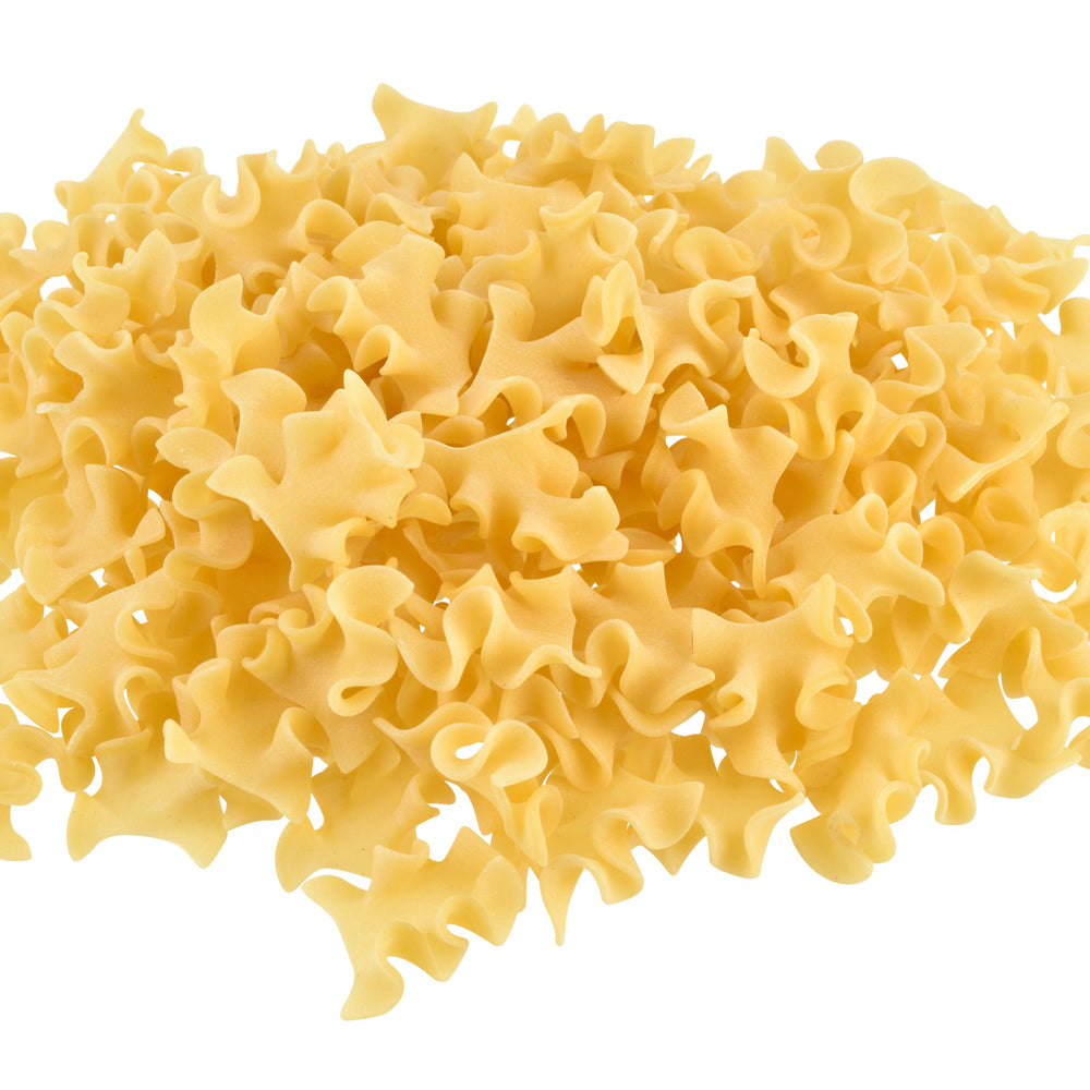 Pile of uncooked sagne e pezzi pasta on a white background