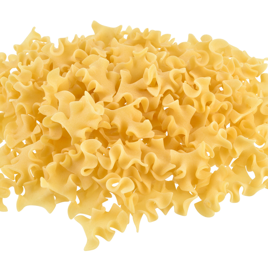 Pile of uncooked sagne e pezzi pasta on a white background