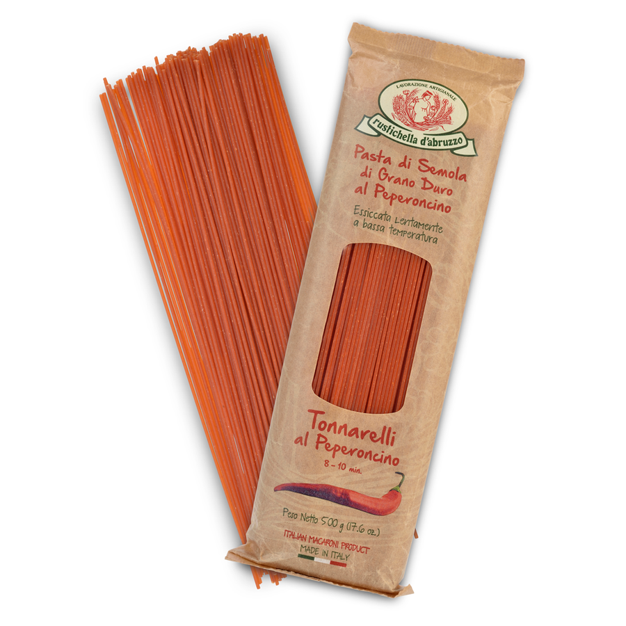 Red pasta strands next to a brown package with branding on a white background