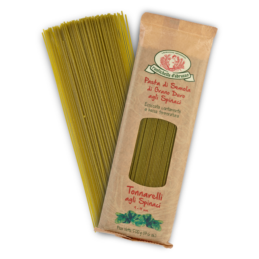 Green spaghetti pasta with a brown package on a white background