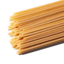 Close up of Tirrena Spaghetti pasta against a white background