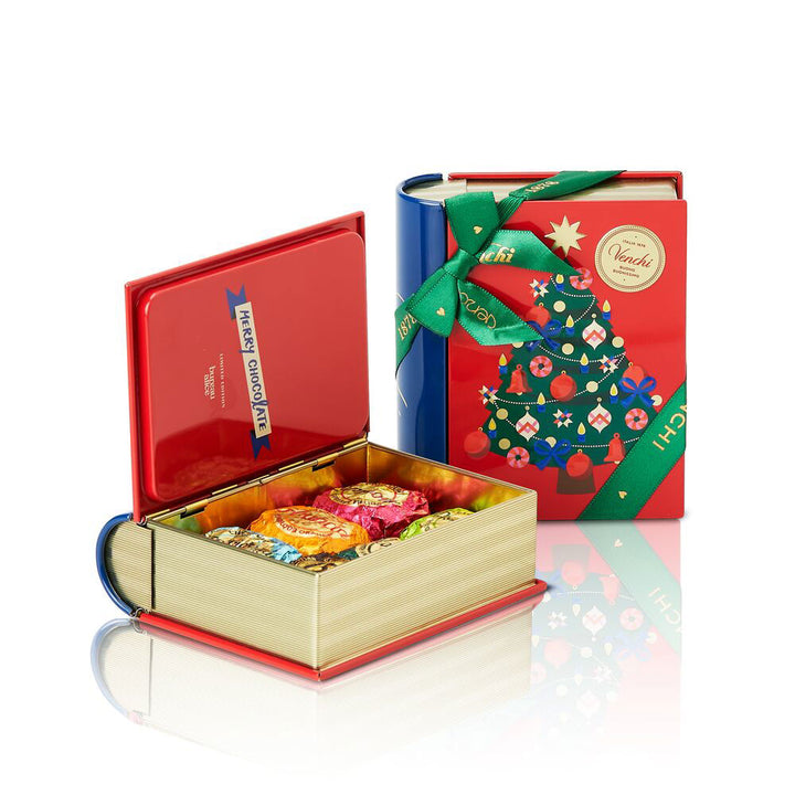 Decorative gift box with a book-shaped container filled with chocolates on a white background