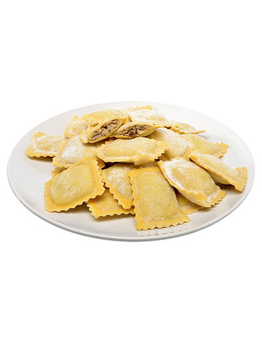 A white plate filled with fresh ravioli