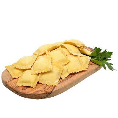 Fresh ravioli on wood board