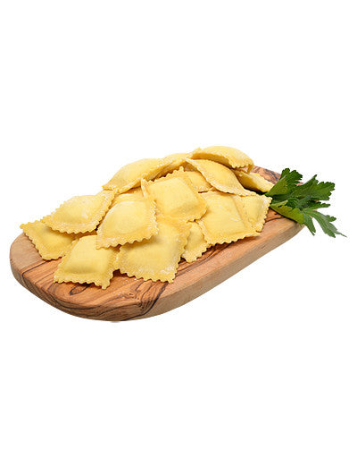 Fresh ravioli on a wood board