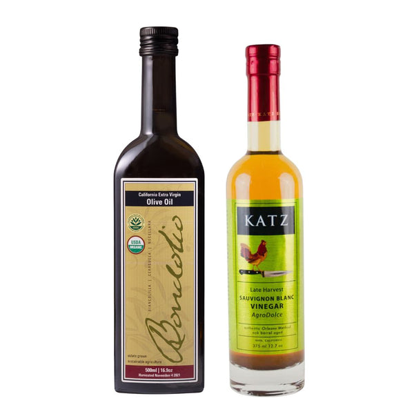 One bottle of Bondoli California Extra Virgin Olive Oil next to a bottle of Katz Late Harvest Sauvignon Blanc White Wine Vinegar