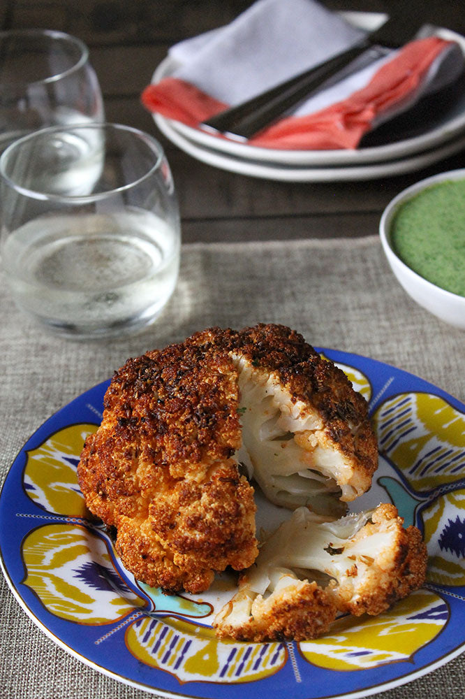 Spiced Whole Roasted Cauliflower with Green Herb Yogurt Sauce
