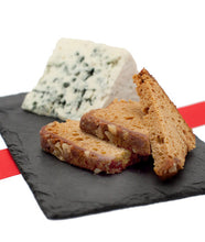 slices of pain d'epices with blue cheese on a black cheese board