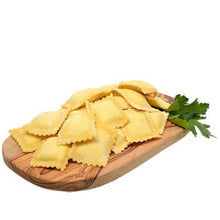 Fresh ravioli on a wood board