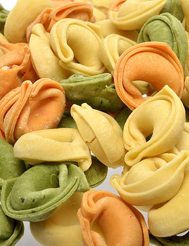 Close up of green, white and red cheese tortellini