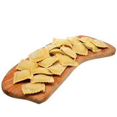 Fresh ravioli on a wood board