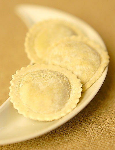 Fresh ravioli on a white plate